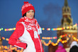Smiling girl in red at GUM-Skating rink on Red Square in Moscow,