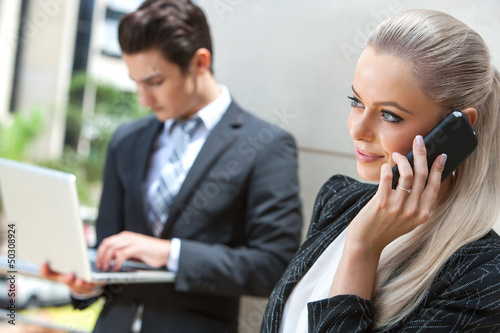Photo: Elegant Businesswoman talking on smart phone. Elegant Businesswoman talking on smart phone.