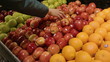 Women Selecting Organic Red Apples to Buy