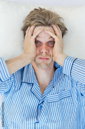 Photo: Stressed man can't sleep Stressed man can't sleep