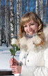 Photo: Pretty young woman with rose , winter season Pretty young woman with rose , winter season
