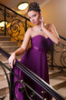 woman in a beautiful dress sloit on the stairs
