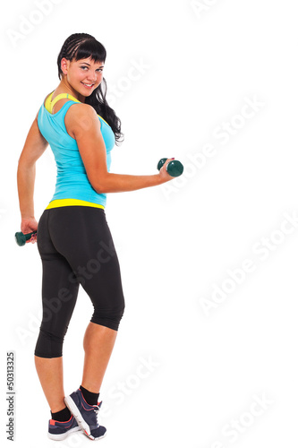 Photo: Young happy brunette exercising with dumbbells Young happy brunette exercising with dumbbells