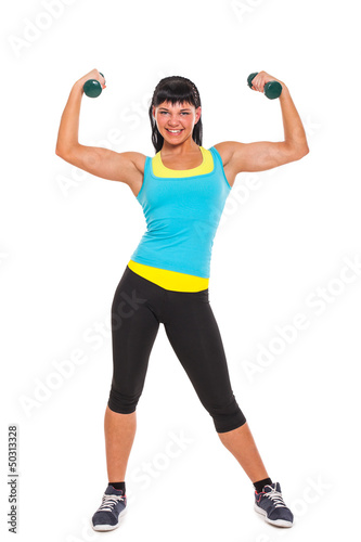 Photo: Young happy brunette exercising with dumbbells Young happy brunette exercising with dumbbells