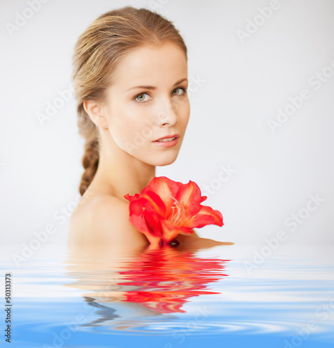 Photo: lovely woman with lily flower in water lovely woman with lily flower in water