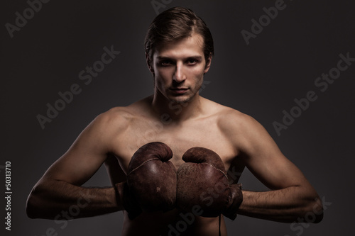 Photo: Handsome guy in a boxing gloves Handsome guy in a boxing gloves