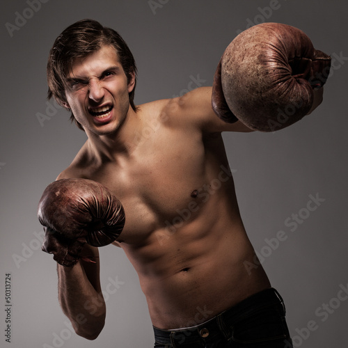 Photo: Agressive guy in a boxing gloves Agressive guy in a boxing gloves