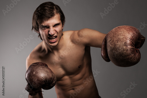 Photo: Agressive guy in a boxing gloves Agressive guy in a boxing gloves