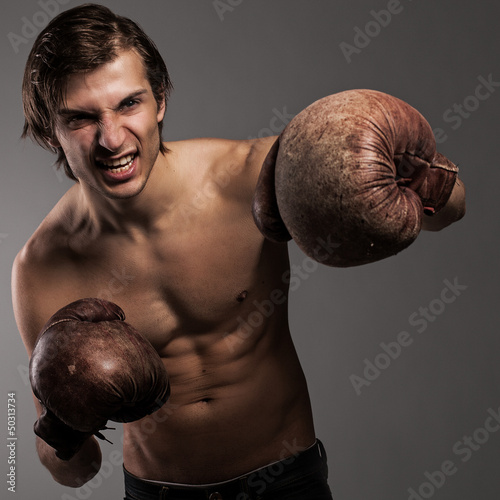 Photo: Agressive guy in a boxing gloves Agressive guy in a boxing gloves