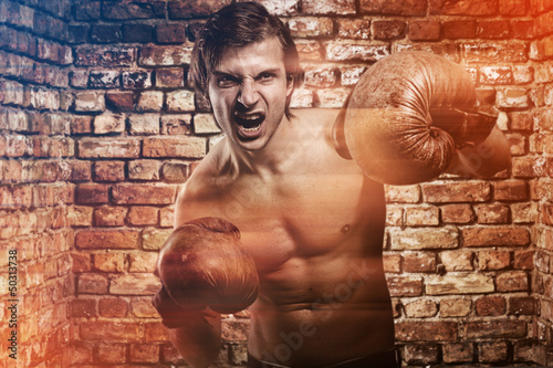 Photo: Agressive guy in a boxing gloves Agressive guy in a boxing gloves