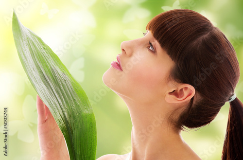 Photo: woman with green leaf and butterflies woman with green leaf and butterflies