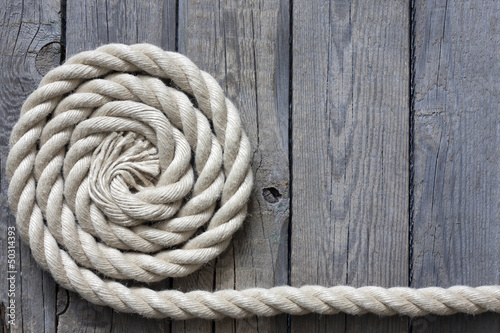 Photo: Rope on old vintage wooden planks abstract background Rope on old vintage wooden planks abstract background