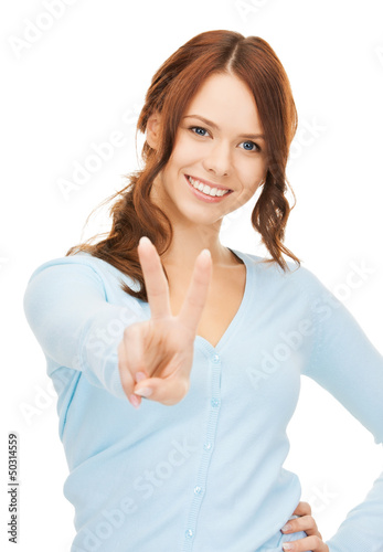 Photo: woman showing victory or peace sign woman showing victory or peace sign