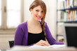 Smiling young student in a library