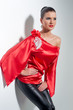 girl posing in red silk tunic and black leggings