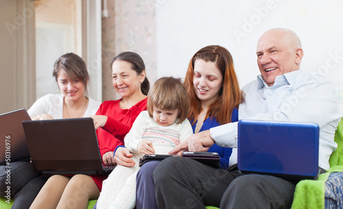 Photo: family uses electronic devices together family uses electronic devices together