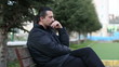 sad man sitting a bank, steady cam shoot