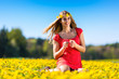 Photo: Girl in spring on a flower meadow with dandelion Girl in spring on a flower meadow with dandelion