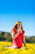 Photo: Girl in spring on a flower meadow with dandelion Girl in spring on a flower meadow with dandelion