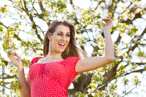 Photo: Girl in spring and tree blossom Girl in spring and tree blossom