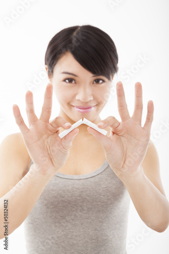 Photo: young woman breaking cigarette and stop smoking young woman breaking cigarette and stop smoking
