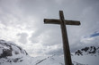 cross on top of swiss mountain in winter