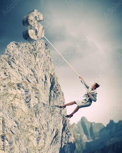 Photo: businesswoman climbing mountain businesswoman climbing mountain