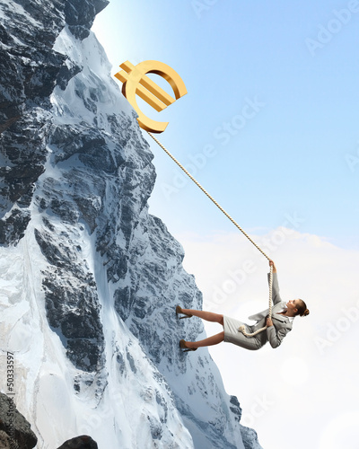 Photo: businesswoman climbing mountain businesswoman climbing mountain