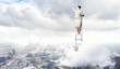 Businesswoman standing on ladder