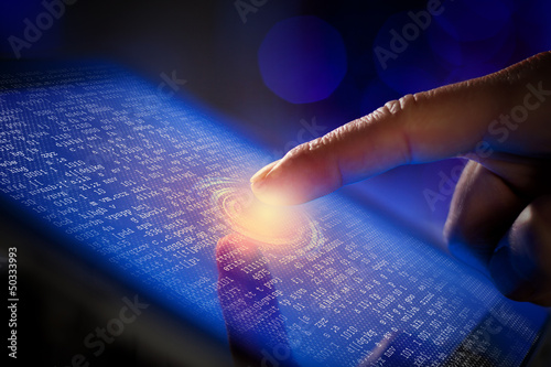 Photo: Closeup of finger touching tablet-pc screen Closeup of finger touching tablet-pc screen