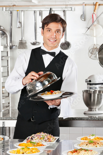 Photo: Waiter Lifting The Cover Of Cloche Waiter Lifting The Cover Of Cloche