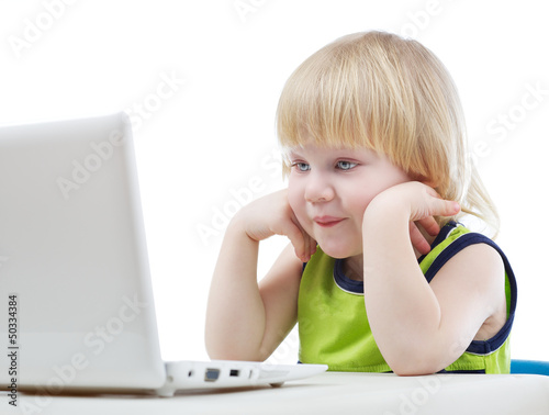 Photo: Young blonde boy looking at computer screen Young blonde boy looking at computer screen