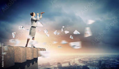 Photo: Business woman with telescope Business woman with telescope