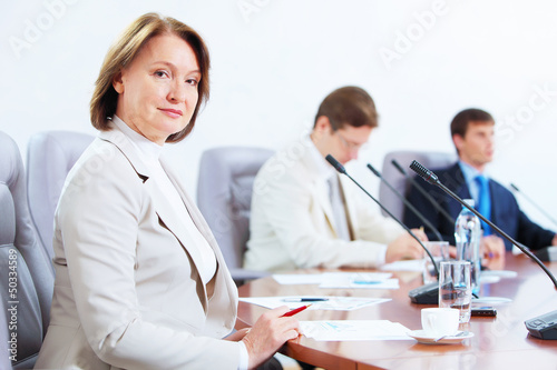 Photo: Three businesspeople at meeting Three businesspeople at meeting