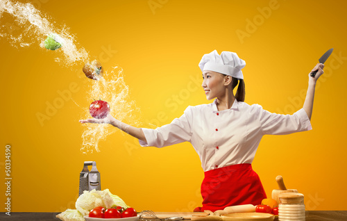 Photo: Asian female cook with knife Asian female cook with knife