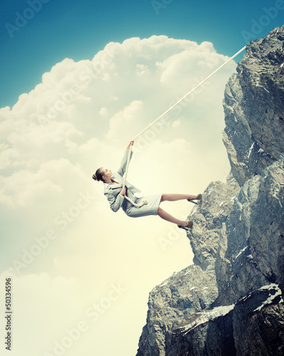 Photo: businesswoman climbing mountain businesswoman climbing mountain