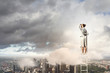 Businesswoman standing on ladder
