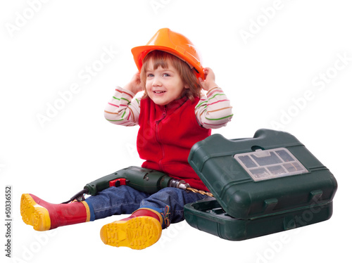 Photo: Happy child in hardhat with tools Happy child in hardhat with tools