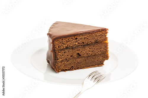 Photo: Ein Stück Sachertorte auf Teller mit Gabel Ein Stück Sachertorte auf Teller mit Gabel