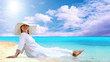 Young beautiful women in the white on the sunny tropical beach