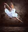 Woman dancer jump posing on background