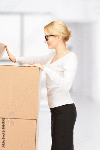 Photo: attractive businesswoman with big boxes attractive businesswoman with big boxes