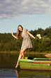 Young girl posing on boat with bouquet of flowers