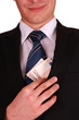A businessman in a black suit putting money in his pocket isolat
