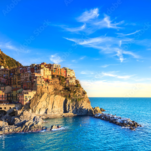 Photo: Manarola village, rocks and sea at sunset. Cinque Terre, Italy Manarola village, rocks and sea at sunset. Cinque Terre, Italy