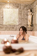 Pretty young woman relaxing in the hot tub
