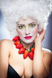 Woman with strawberry necklace, wig and professional makeup