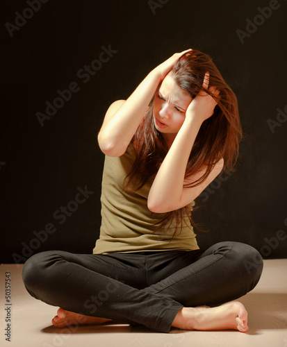 Photo: Depressed woman sitting on floor with eyes closed Depressed woman sitting on floor with eyes closed