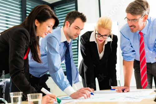 Photo: Business - People in office working as team Business - People in office working as team