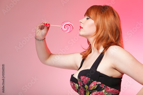 Photo: happy redhair woman with lollipop candy happy redhair woman with lollipop candy
